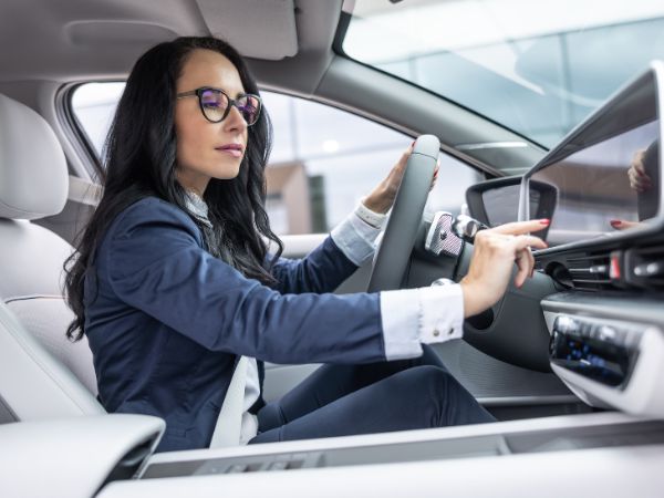 Driver interacting with an AI-powered smart cockpit system inside a modern intelligent vehicle